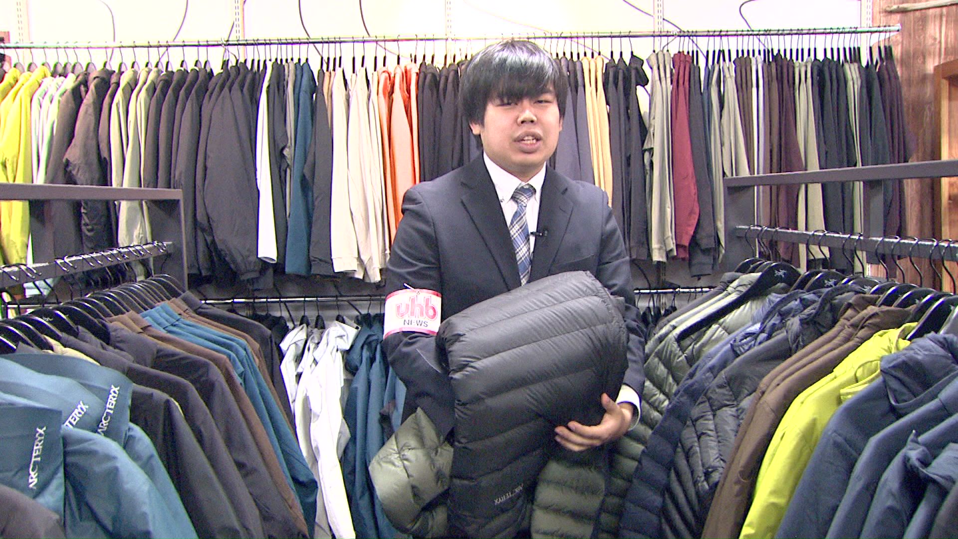 商品を隠す様子を再現する川瀬雄也記者