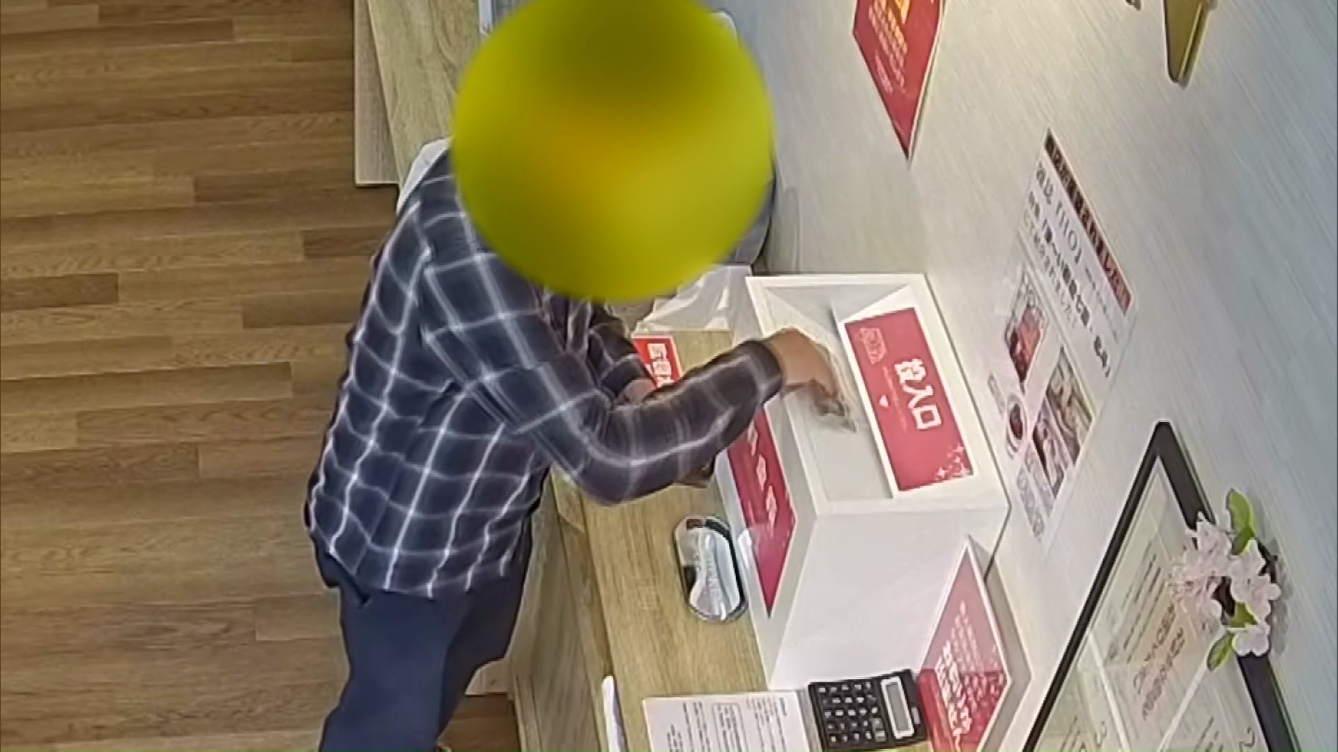 料金箱に現金を入れる様子