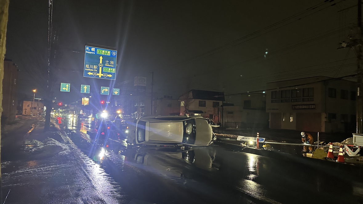 乗用車は中央分離帯に衝突して横転した(北海道旭川市)