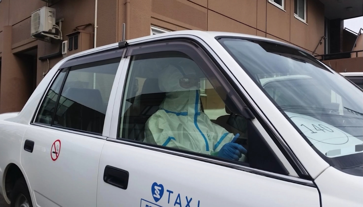 防護服を着てコロナ感染者を搬送