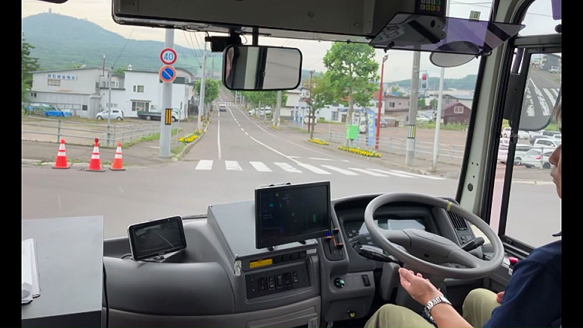 ハンドルに触れずに交差点を左折するバス