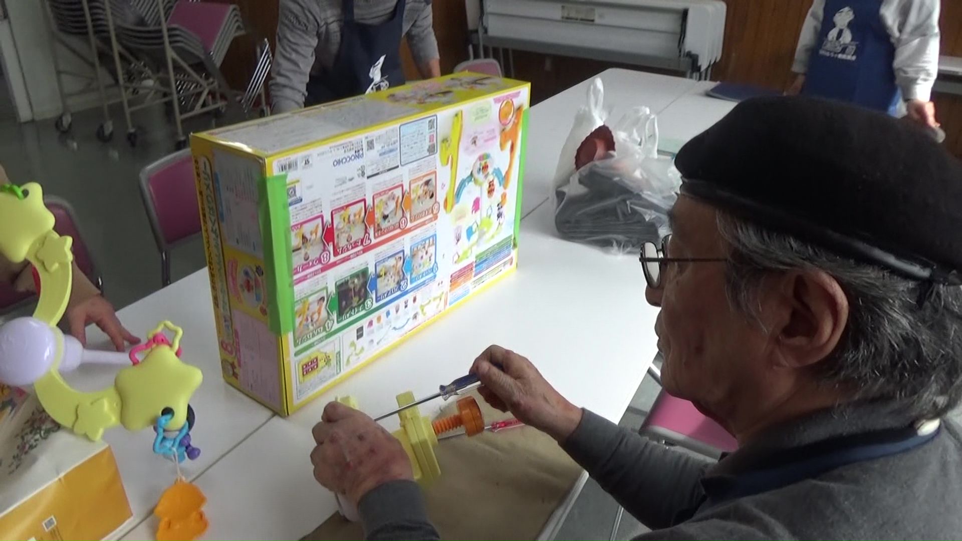 持ち込まれたおもちゃを診察する高橋さん